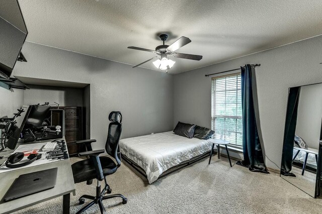 870 1st St, Maypearl, TX 76064 - carpeted bedroom with an office area, a textured ceiling, a textured wall, and ceiling fan