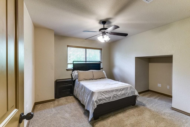 870 1st St, Maypearl, TX 76064 - bedroom with light carpet, baseboards, a ceiling fan, and a textured ceiling