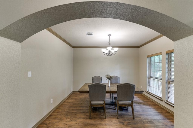 870 1st St, Maypearl, TX 76064 - dining room featuring crown molding, arched walkways, a chandelier, wood finished floors, and baseboards