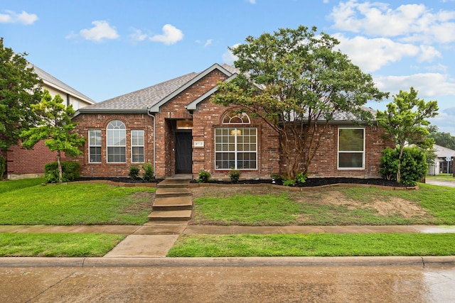 4719 Highlands Dr, Mckinney, TX 75070 - view of front of home with a front yard, brick siding, and roof with shingles