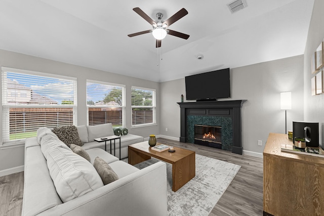 4719 Highlands Dr, Mckinney, TX 75070 - living room with a ceiling fan, baseboards, wood finished floors, a high end fireplace, and vaulted ceiling