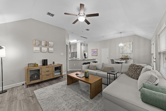 4719 Highlands Dr, Mckinney, TX 75070 - living room featuring vaulted ceiling, a ceiling fan, wood finished floors, and baseboards