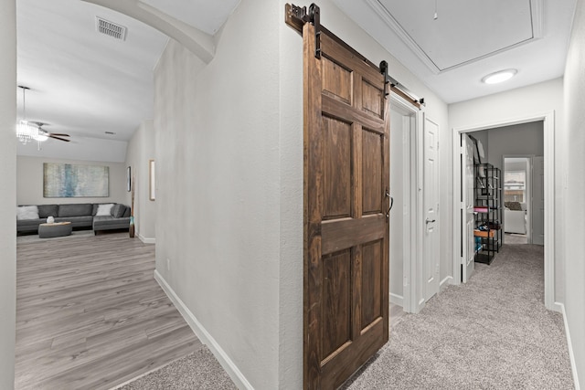 4719 Highlands Dr, Mckinney, TX 75070 - hall featuring baseboards, a barn door, and attic access