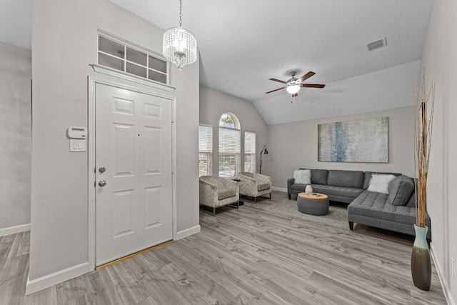 4719 Highlands Dr, Mckinney, TX 75070 - living area with baseboards, a ceiling fan, vaulted ceiling, light wood-type flooring, and a chandelier