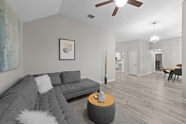 4719 Highlands Dr, Mckinney, TX 75070 - living area with ceiling fan, arched walkways, light wood-style flooring, baseboards, and vaulted ceiling