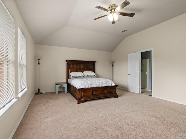 bedroom with light colored carpet, lofted ceiling, baseboards, and ceiling fan