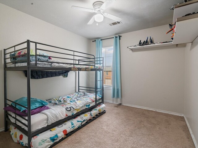 bedroom with carpet flooring, baseboards, and ceiling fan