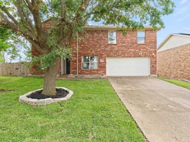 traditional home featuring an attached garage, concrete driveway, and brick siding