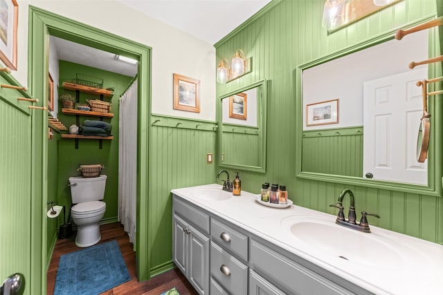 108 Honeysuckle Dr, Justin, TX 76247 - bathroom with wood finished floors, toilet, double vanity, and wainscoting