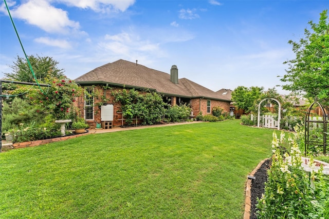 108 Honeysuckle Dr, Justin, TX 76247 - back of property featuring brick siding, a lawn, a chimney, and roof with shingles