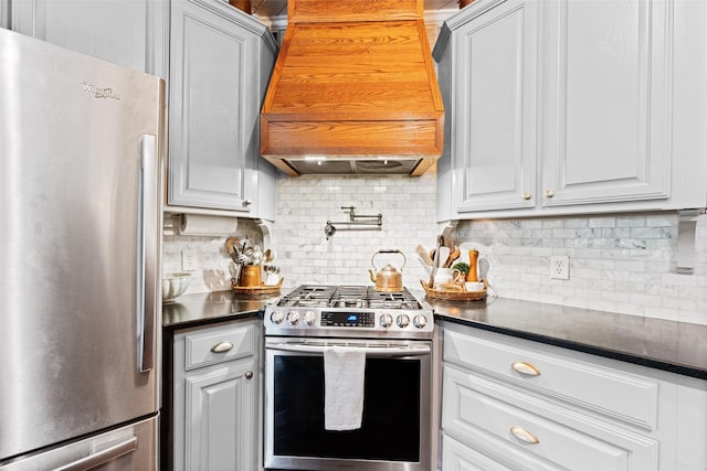 108 Honeysuckle Dr, Justin, TX 76247 - kitchen featuring stainless steel appliances, premium range hood, dark countertops, and decorative backsplash
