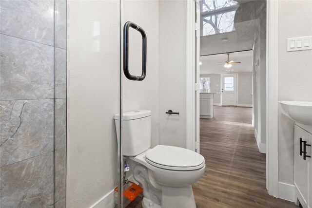 4205 Humphrey Dr, Dallas, TX 75216 - bathroom with wood finished floors, toilet, ceiling fan, and baseboards