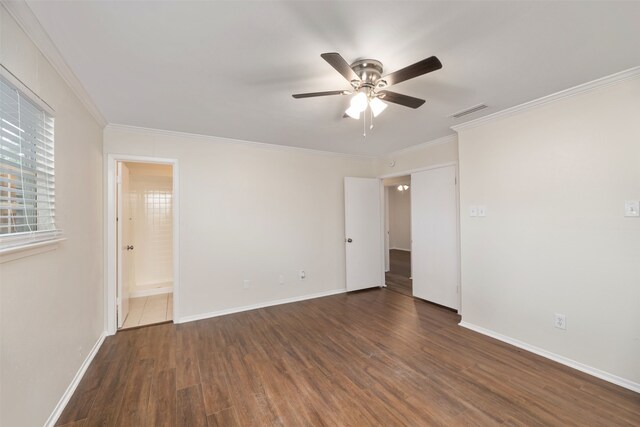 empty room with ceiling fan, wood finished floors, ornamental molding, and baseboards