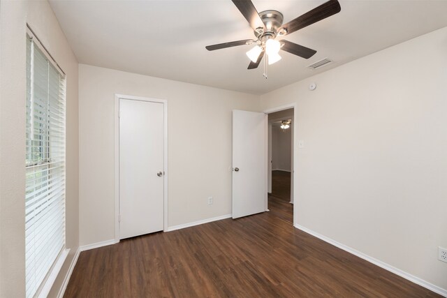 unfurnished bedroom with wood finished floors, baseboards, and ceiling fan