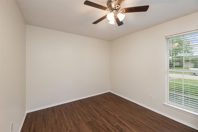 unfurnished room with dark wood-style flooring, baseboards, and a ceiling fan