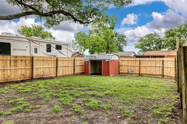view of yard featuring a shed and an outbuilding