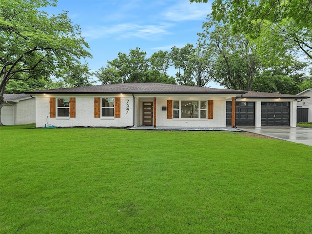 737 Finland St, Grand Prairie, TX 75050 - view of front of home with driveway, a garage, brick siding, a front lawn, and a porch