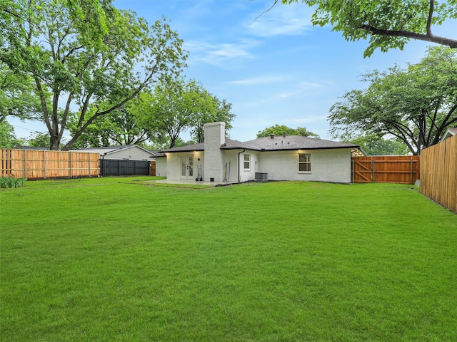 737 Finland St, Grand Prairie, TX 75050 - rear view of house with a chimney, brick siding, and central AC