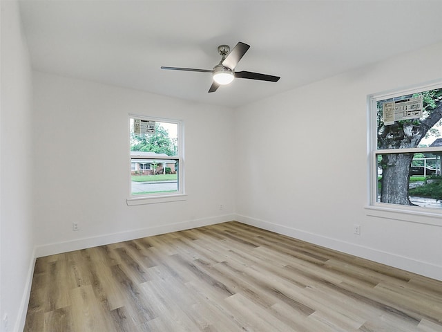 737 Finland St, Grand Prairie, TX 75050 - unfurnished room with light wood-style flooring, ceiling fan, and baseboards