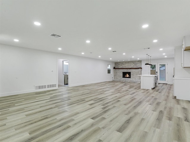 737 Finland St, Grand Prairie, TX 75050 - unfurnished living room with recessed lighting, light wood-type flooring, baseboards, and a fireplace