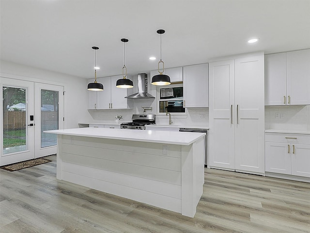 737 Finland St, Grand Prairie, TX 75050 - kitchen with stainless steel appliances, wall chimney range hood, light countertops, french doors, and recessed lighting
