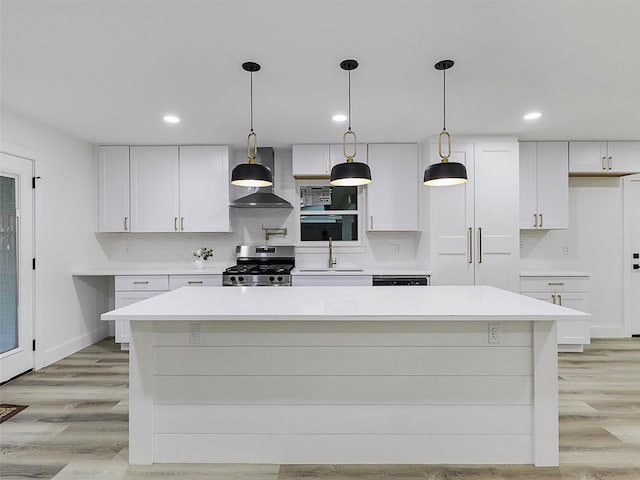 737 Finland St, Grand Prairie, TX 75050 - kitchen featuring stainless steel range with gas cooktop, wall chimney exhaust hood, a sink, light countertops, and white cabinets
