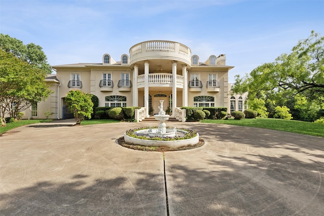 800 John Mccain Rd, Colleyville, TX 76034 - neoclassical home with a balcony, curved driveway, and stucco siding