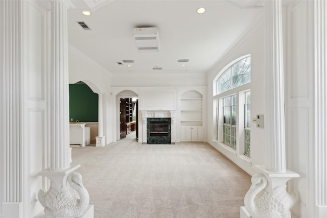 800 John Mccain Rd, Colleyville, TX 76034 - unfurnished living room with crown molding, light colored carpet, arched walkways, a high end fireplace, and recessed lighting