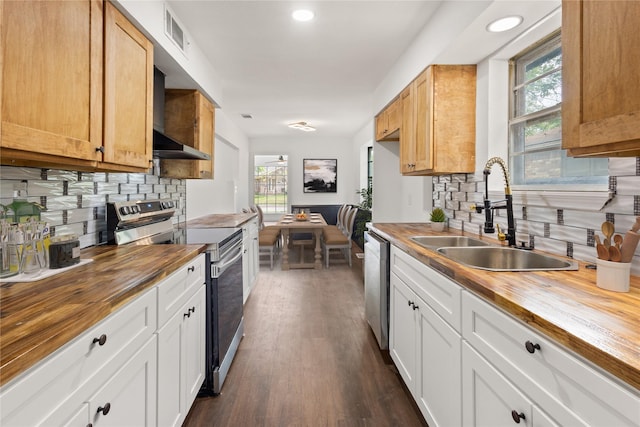 5726 Enchanted Ln, Dallas, TX 75227 - kitchen with wooden counters, stainless steel appliances, a sink, tasteful backsplash, and dark wood-style flooring