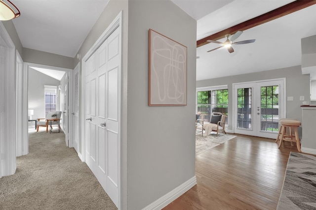 corridor featuring baseboards and wood finished floors