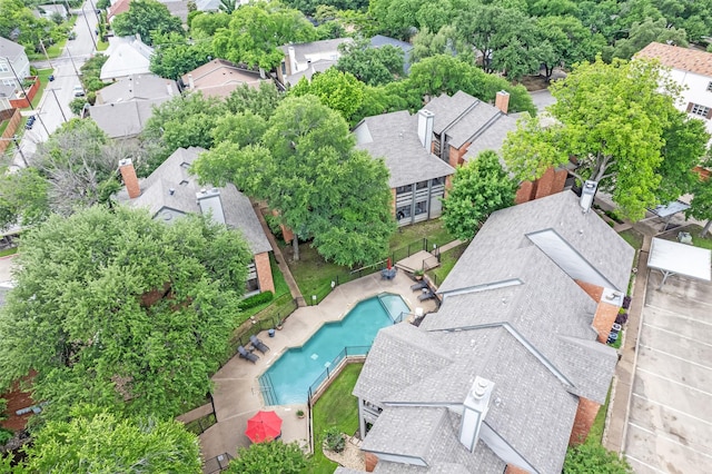 aerial perspective of suburban area featuring a pool