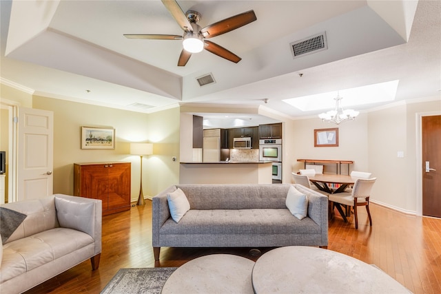 5909 Luther Ln Unit 1700, Dallas, TX 75225 - living room featuring a tray ceiling, hardwood / wood-style floors, a chandelier, ceiling fan, and crown molding