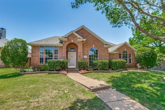 view of front of home featuring brick siding and a shingled roof