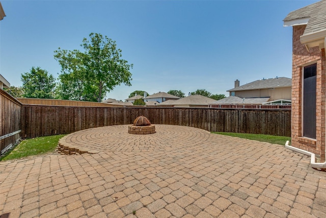 view of patio / terrace featuring a fenced backyard and an outdoor fire pit