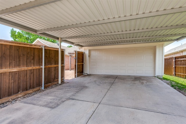 garage with fence and a garage