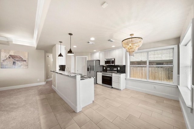 816 Ridgecrest Ct, Aubrey, TX 76227 - kitchen with stainless steel appliances, white cabinets, tasteful backsplash, a peninsula, and a chandelier