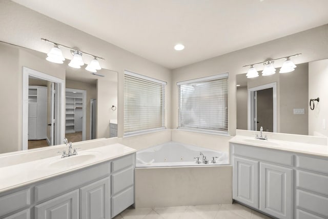 816 Ridgecrest Ct, Aubrey, TX 76227 - bathroom featuring two vanities, tile patterned flooring, a jetted tub, and a walk in closet