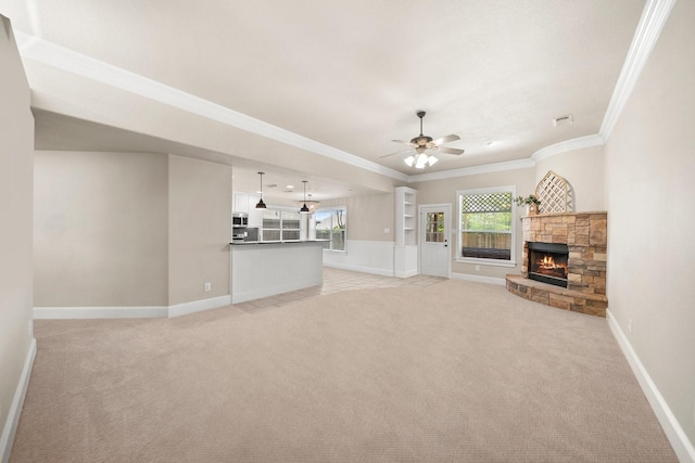 816 Ridgecrest Ct, Aubrey, TX 76227 - unfurnished living room with light carpet, ornamental molding, a stone fireplace, ceiling fan, and baseboards
