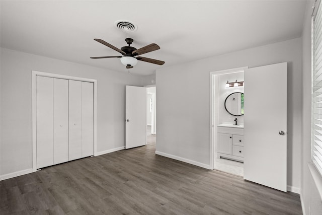 2001 Brenda Ave, Denison, TX 75020 - unfurnished bedroom featuring wood finished floors, a sink, a closet, and baseboards
