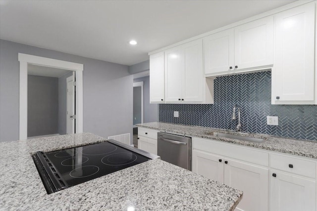 3015 S Fannin Ave, Denison, TX 75021 - kitchen with dishwasher, a sink, cooktop, backsplash, and white cabinets