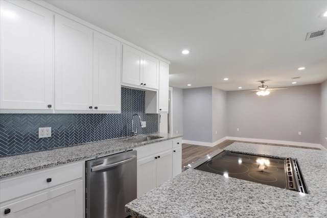 3015 S Fannin Ave, Denison, TX 75021 - kitchen featuring stainless steel dishwasher, a sink, black electric cooktop, backsplash, and recessed lighting