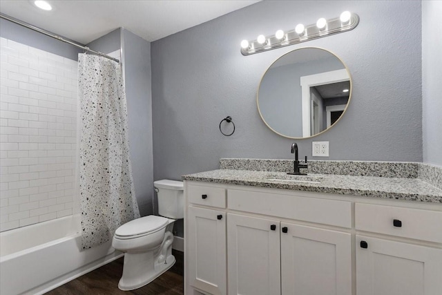 3015 S Fannin Ave, Denison, TX 75021 - full bath featuring wood finished floors, toilet, vanity, and shower / bath combo with shower curtain