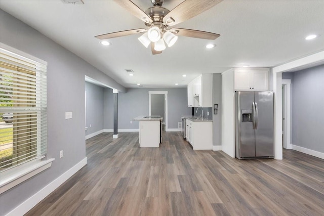 3015 S Fannin Ave, Denison, TX 75021 - kitchen with stainless steel fridge, white cabinets, dark wood-style floors, a ceiling fan, and baseboards