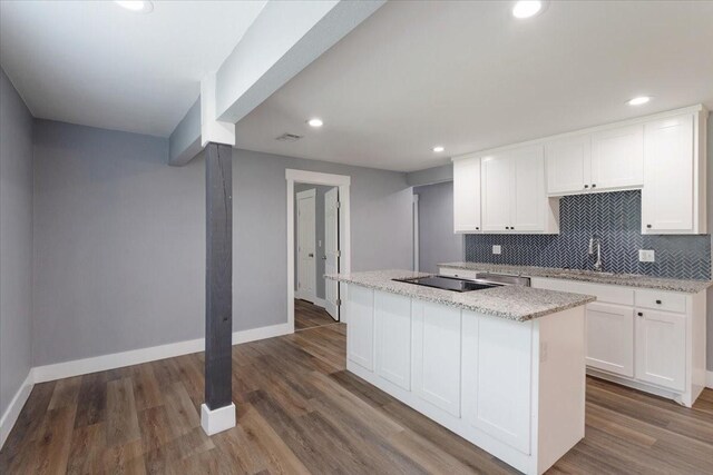 3015 S Fannin Ave, Denison, TX 75021 - kitchen featuring a center island, baseboards, white cabinetry, tasteful backsplash, and recessed lighting