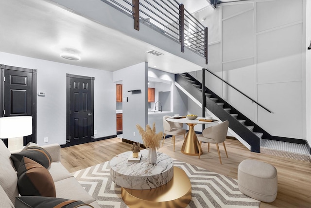 3103 Wycliff Ave, Dallas, TX 75219 - living area with light wood-type flooring, stairs, and baseboards
