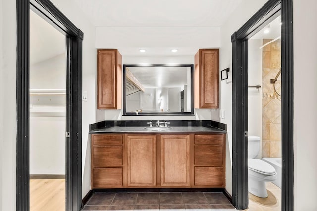 3103 Wycliff Ave, Dallas, TX 75219 - bathroom with toilet, vanity, a shower, and tile patterned flooring