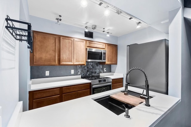 3103 Wycliff Ave, Dallas, TX 75219 - kitchen with stainless steel appliances, a sink, tasteful backsplash, and light countertops