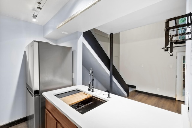 3103 Wycliff Ave, Dallas, TX 75219 - kitchen with a sink, freestanding refrigerator, brown cabinetry, and light countertops