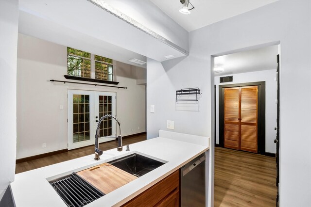 3103 Wycliff Ave, Dallas, TX 75219 - kitchen featuring a sink, stainless steel dishwasher, french doors, wood finished floors, and light countertops