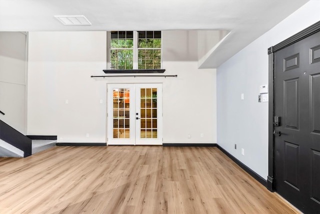 3103 Wycliff Ave, Dallas, TX 75219 - entryway featuring light wood-type flooring, french doors, and baseboards